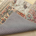 Handmade 5x7 patchwork Turkish rug with vibrant floral wool patterns and a grey striped cotton backing.