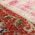 Handmade Turkish patchwork area rug featuring vibrant red and pink floral wool patterns with visible hand-stitched details.