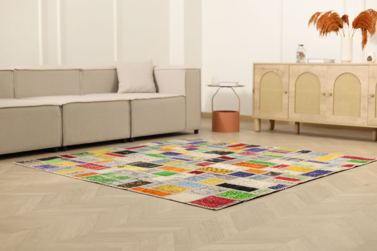 6.5x6.5 ft handmade patchwork Turkish rug with vibrant geometric wool and cotton squares in a modern living room.