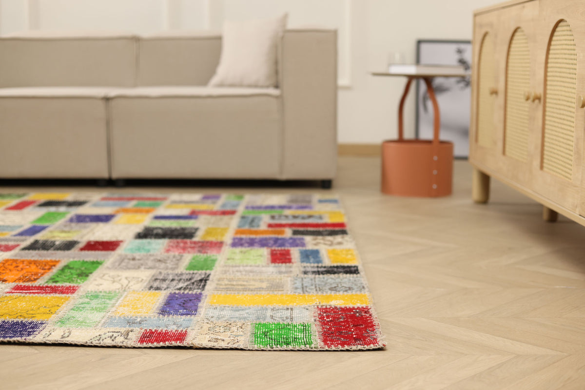 6.5x6.5 ft handmade patchwork Turkish rug with vibrant geometric wool and cotton squares in a modern living room.