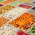 Handmade vintage Turkish patchwork area rug featuring vibrant geometric patterns in wool and cotton.