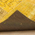 Yellow vintage Turkish patchwork area rug with wool and cotton construction and a protective fabric backing.
