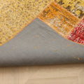 Handmade vintage Turkish patchwork rug in yellow and red with a grey cotton backing, 6x7 ft bohemian style.