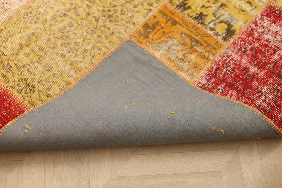 Handmade vintage Turkish patchwork rug in yellow and red with a grey cotton backing, 6x7 ft bohemian style.