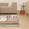 Handmade 6x8 ft patchwork Turkish area rug featuring vibrant, multi-colored striped patterns in a wool and cotton flatweave.