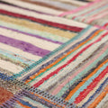 Handmade vintage Turkish patchwork area rug featuring vibrant multicolored stripes and stitched wool and cotton flatweave textures.
