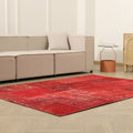 5x7 ft vintage red patchwork area rug made of wool and cotton with overdyed bohemian patterns in a modern living room.