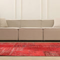 5x7 ft vintage red patchwork Turkish area rug in wool and cotton with overdyed bohemian patterns in a modern living room.