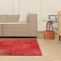5x7 ft red patchwork Turkish area rug made of wool and cotton with a vintage overdyed design in a bohemian living room.