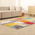 Handmade 5x7 patchwork Turkish area rug featuring vibrant geometric patterns in wool and cotton on a light wood floor.