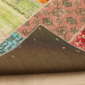 Handmade 5x7 patchwork Turkish rug with vibrant geometric patterns, wool and cotton blend, showing the dark backing.