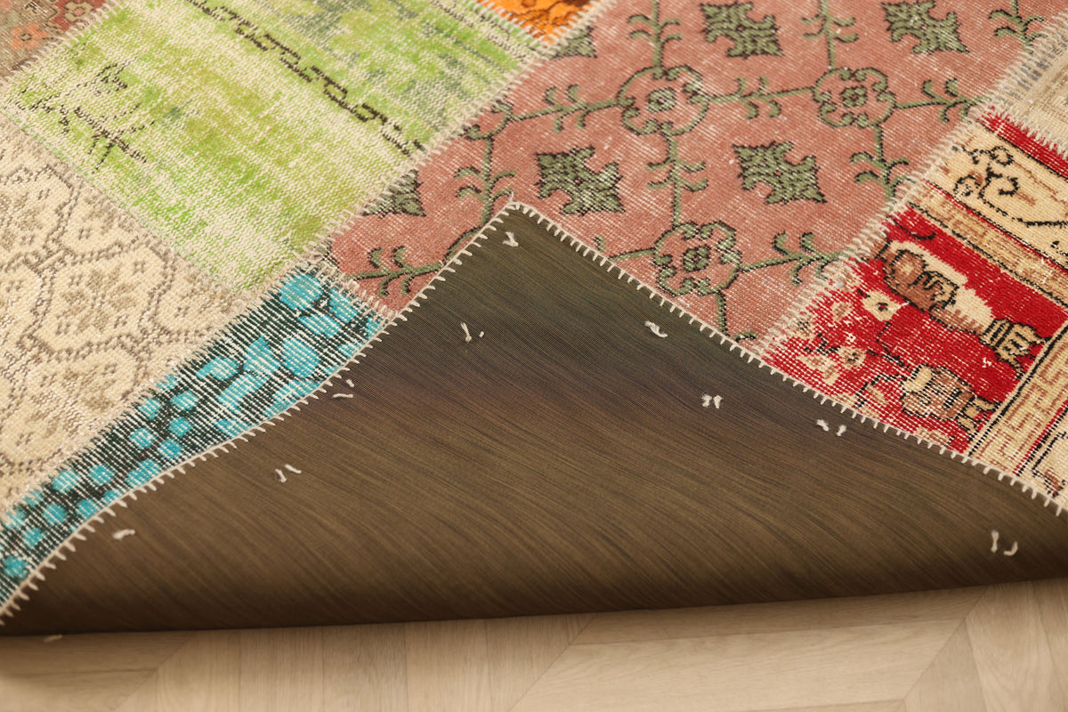 Handmade 5x7 patchwork Turkish rug with vibrant geometric patterns, wool and cotton blend, showing the dark backing.