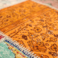 Handmade vintage Turkish patchwork rug with vibrant geometric patterns in wool and cotton, featuring orange and red tones.