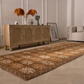 Handwoven 4x12 ft vintage Turkish runner rug in brown and beige with geometric patterns on a light wood floor.
