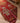 Handmade 3.3x11.5 ft wool and cotton Persian runner rug in red and orange with traditional human-figured patterns.