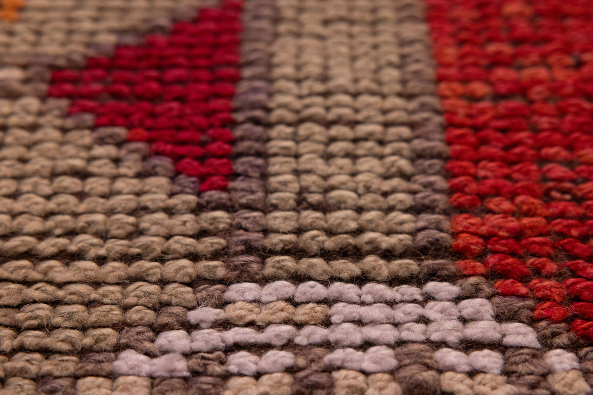 Close-up of a handmade Persian runner rug in red and orange wool-cotton blend with traditional figured patterns.