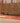 Handmade 3.3x11.5 ft Persian style runner rug in red and orange wool-cotton blend with traditional human-figured patterns.