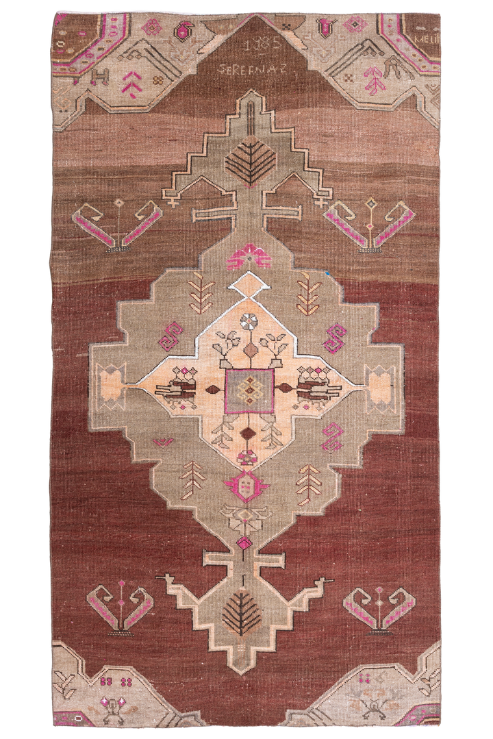 Hand-woven 5x9 ft vintage Kars Turkish rug in brown with geometric patterns, made from wool and cotton.