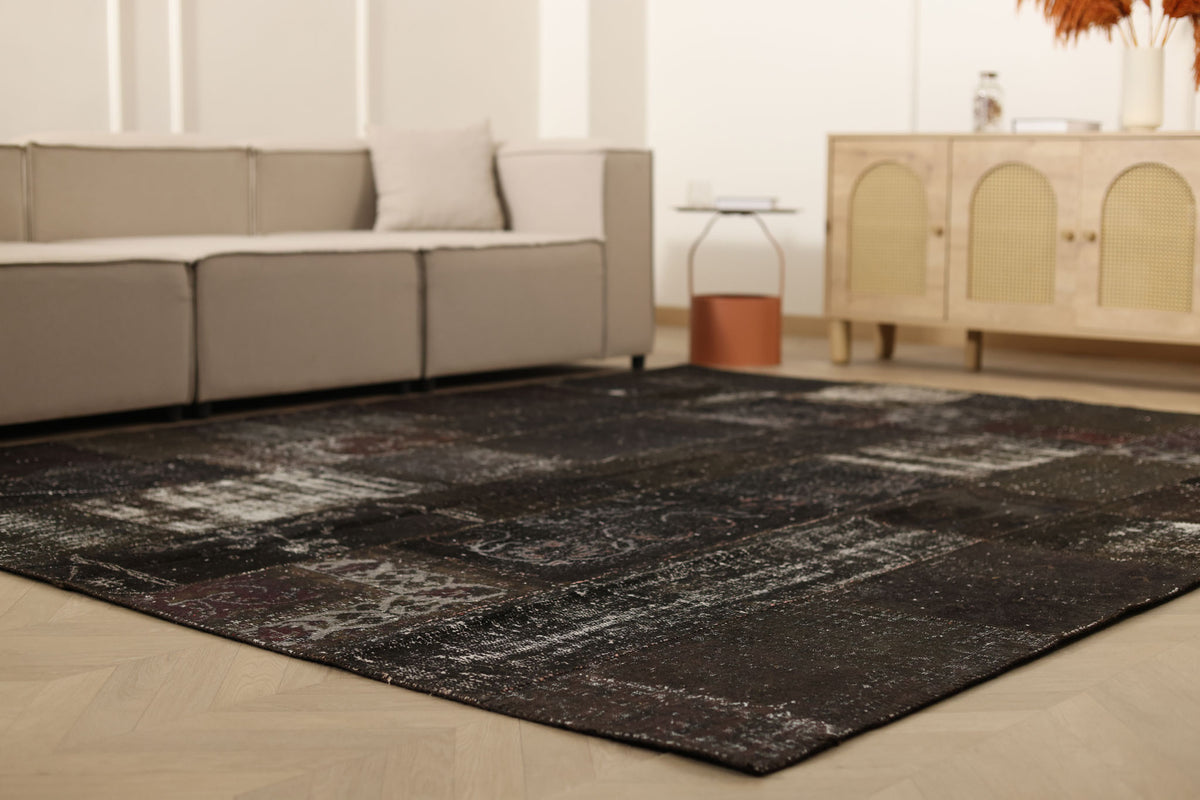 8x9 ft black patchwork vintage Turkish rug with distressed patterns, hand-stitched from wool and cotton in a bohemian style.