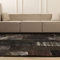 8x9 ft black patchwork Turkish area rug featuring distressed, hand-stitched wool and cotton patterns in a bohemian style.