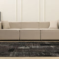 Handmade 6x9 ft black patchwork Turkish area rug with a distressed, vintage-inspired design in wool and cotton.