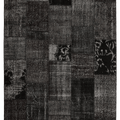 6x9 ft black patchwork vintage Turkish area rug made of hand-stitched wool and cotton with distressed bohemian patterns.