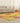 6x9 ft vintage Turkish patchwork area rug in vibrant yellow and red with floral patterns on a hardwood floor.
