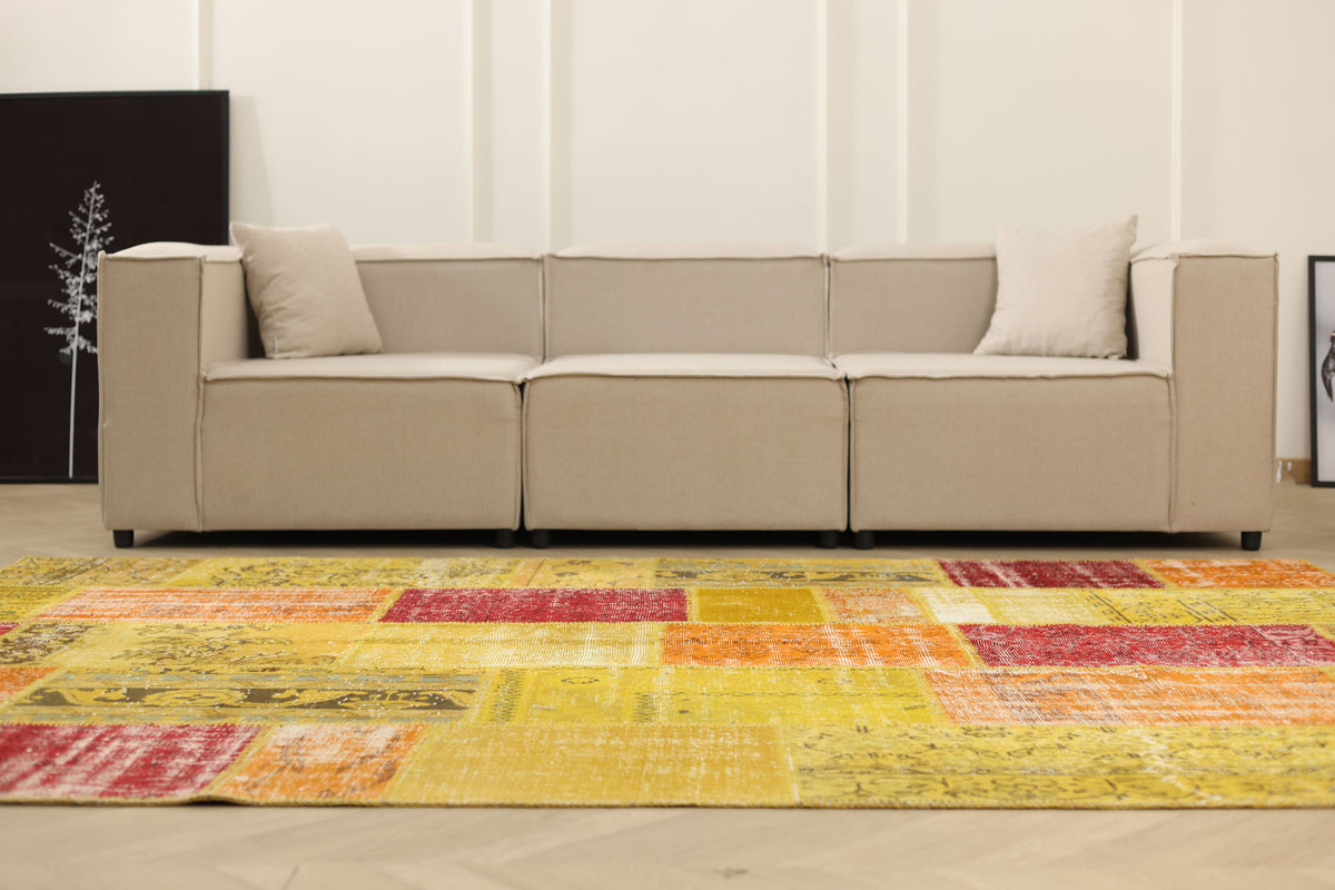 6x9 ft vintage Turkish patchwork area rug featuring vibrant yellow and red floral patterns in wool and cotton.