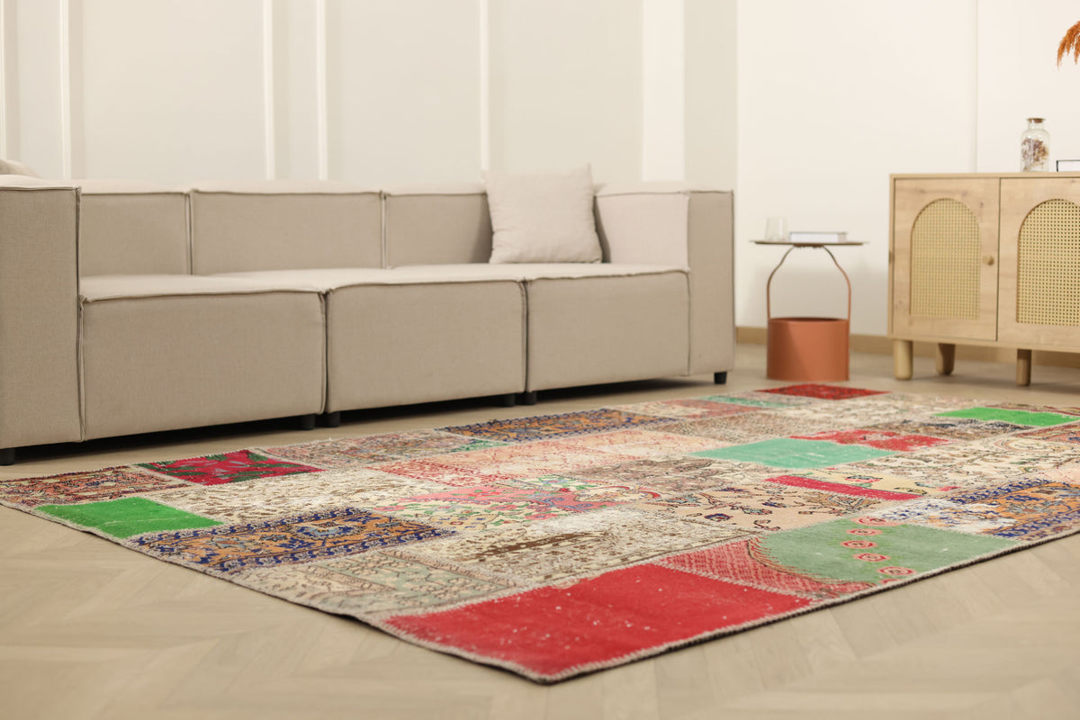 6x10 ft vintage Turkish patchwork area rug with vibrant floral patterns, hand-stitched wool and cotton in a bohemian living room.