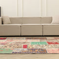6x10 ft handmade Turkish patchwork area rug featuring vibrant floral patterns in wool and cotton in a bohemian living room.