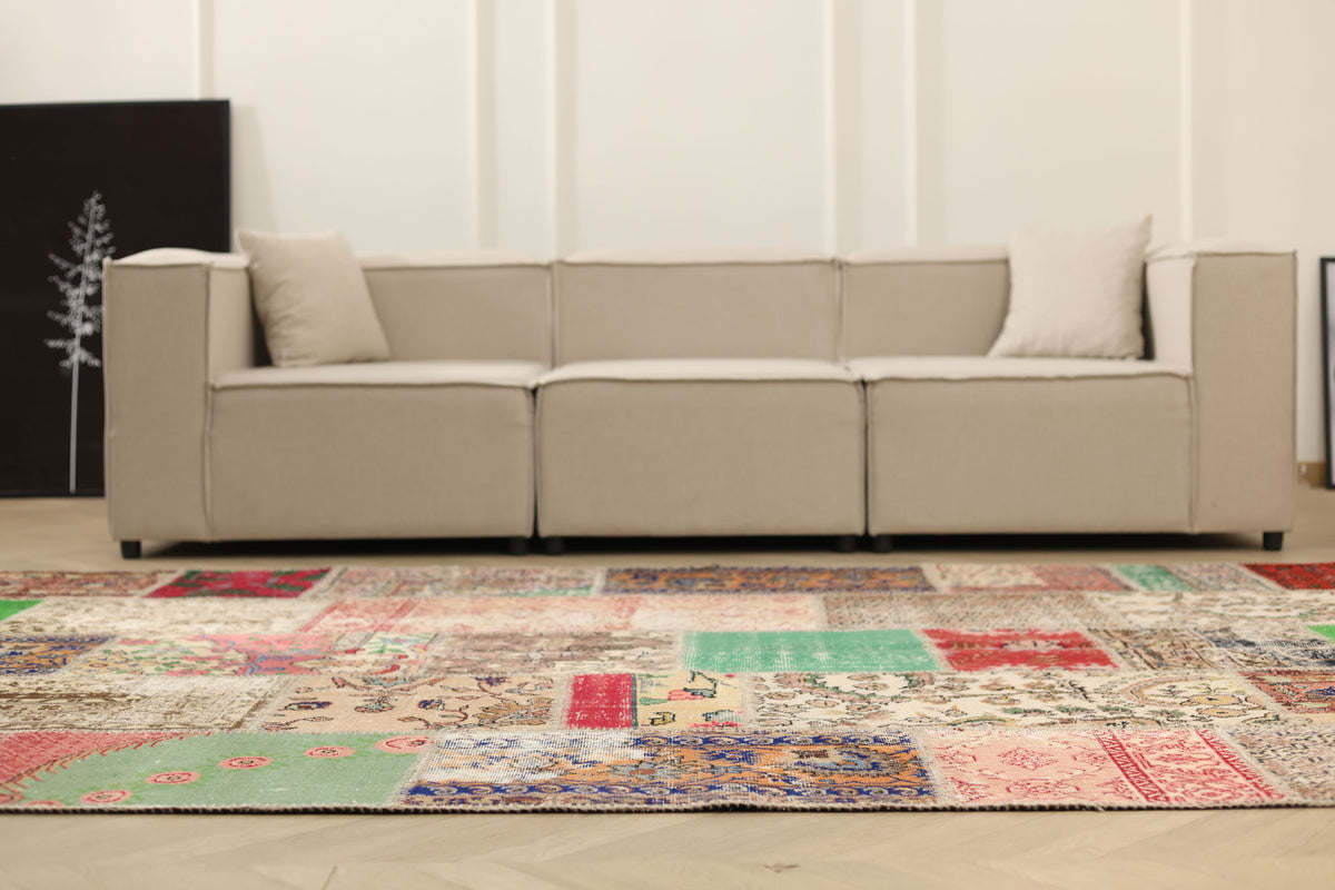 6x10 ft handmade Turkish patchwork area rug featuring vibrant floral patterns in wool and cotton in a bohemian living room.