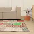 6x10 ft vintage Turkish patchwork area rug featuring vibrant floral patterns in wool and cotton in a modern living room.