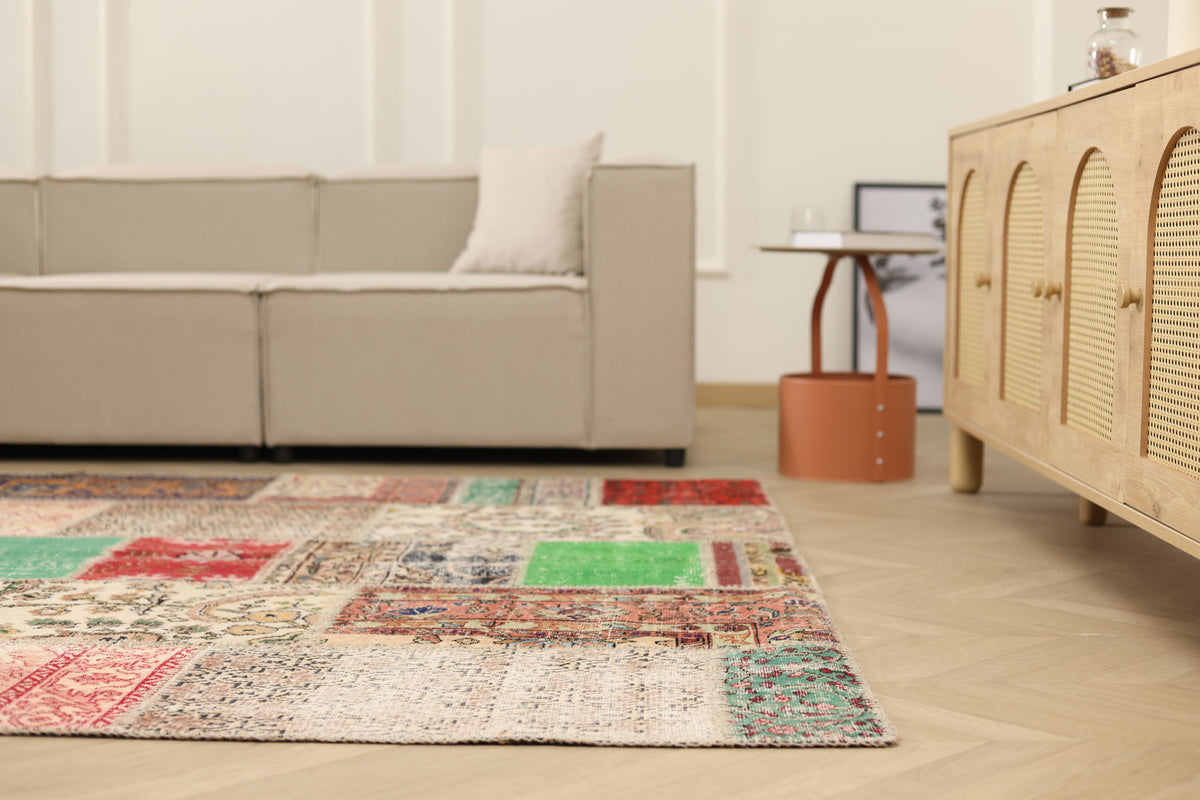 6x10 ft vintage Turkish patchwork area rug featuring vibrant floral patterns in wool and cotton in a modern living room.