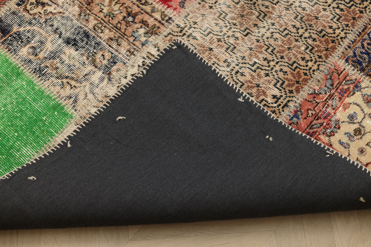 Handmade 6x10 ft vintage Turkish patchwork rug with floral patterns, wool-cotton blend, and a durable black fabric backing.
