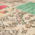 Handmade 6x10 ft vintage Turkish patchwork rug featuring colorful floral patterns in wool and cotton.