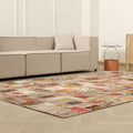 6x9 ft vintage Turkish patchwork area rug with vibrant geometric patterns in wool and cotton on a herringbone floor.