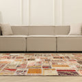 6x9 ft vintage Turkish patchwork area rug with vibrant geometric patterns in wool and cotton in a modern living room.