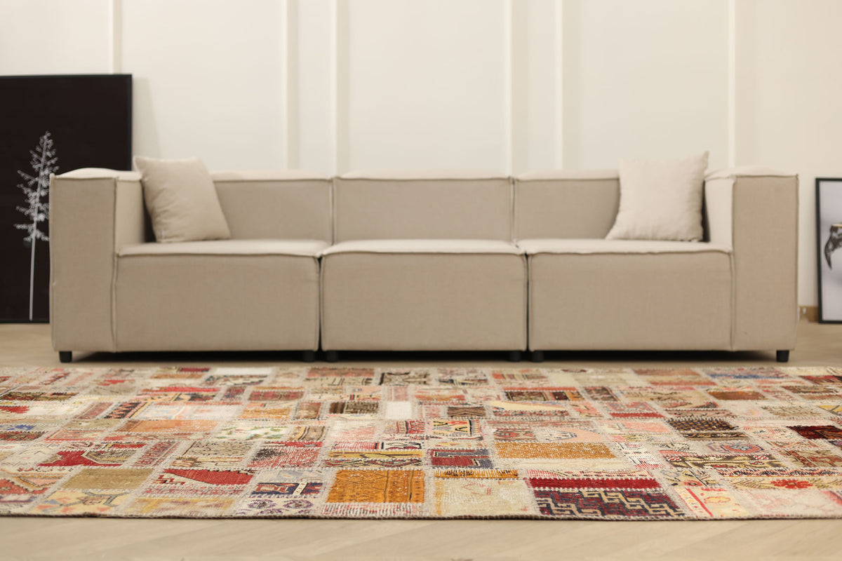 6x9 ft vintage Turkish patchwork area rug with vibrant geometric patterns in wool and cotton in a modern living room.
