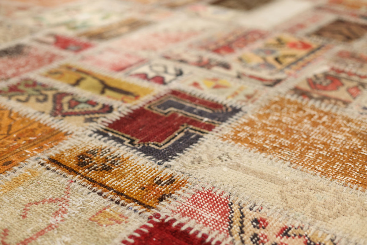 Handmade 6x9 ft vintage Turkish patchwork rug featuring colorful geometric patterns in wool and cotton.