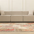 6x9 ft vintage Turkish patchwork area rug with vibrant geometric patterns in wool and cotton in a modern living room.