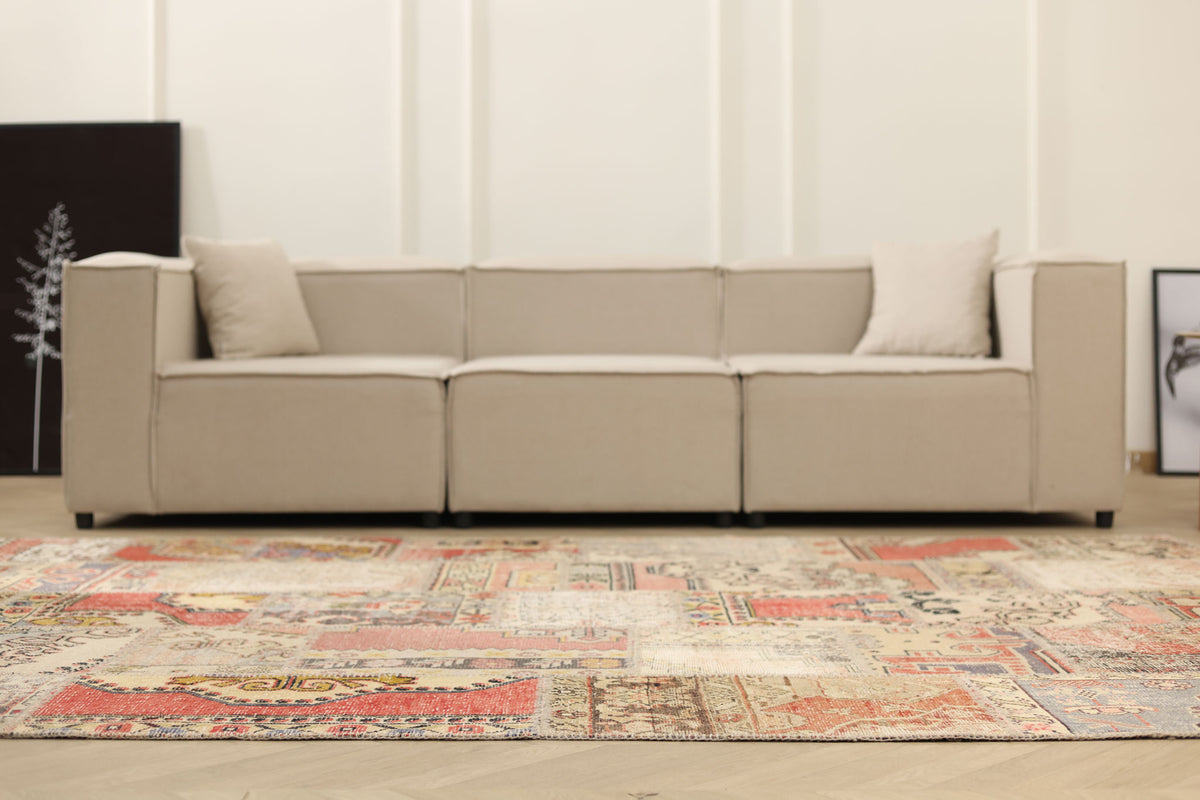 6x9 ft vintage Turkish patchwork area rug with vibrant geometric patterns in wool and cotton in a modern living room.