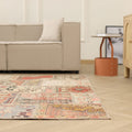 6x9 ft vintage Turkish patchwork area rug with vibrant geometric patterns in wool and cotton on a hardwood floor.
