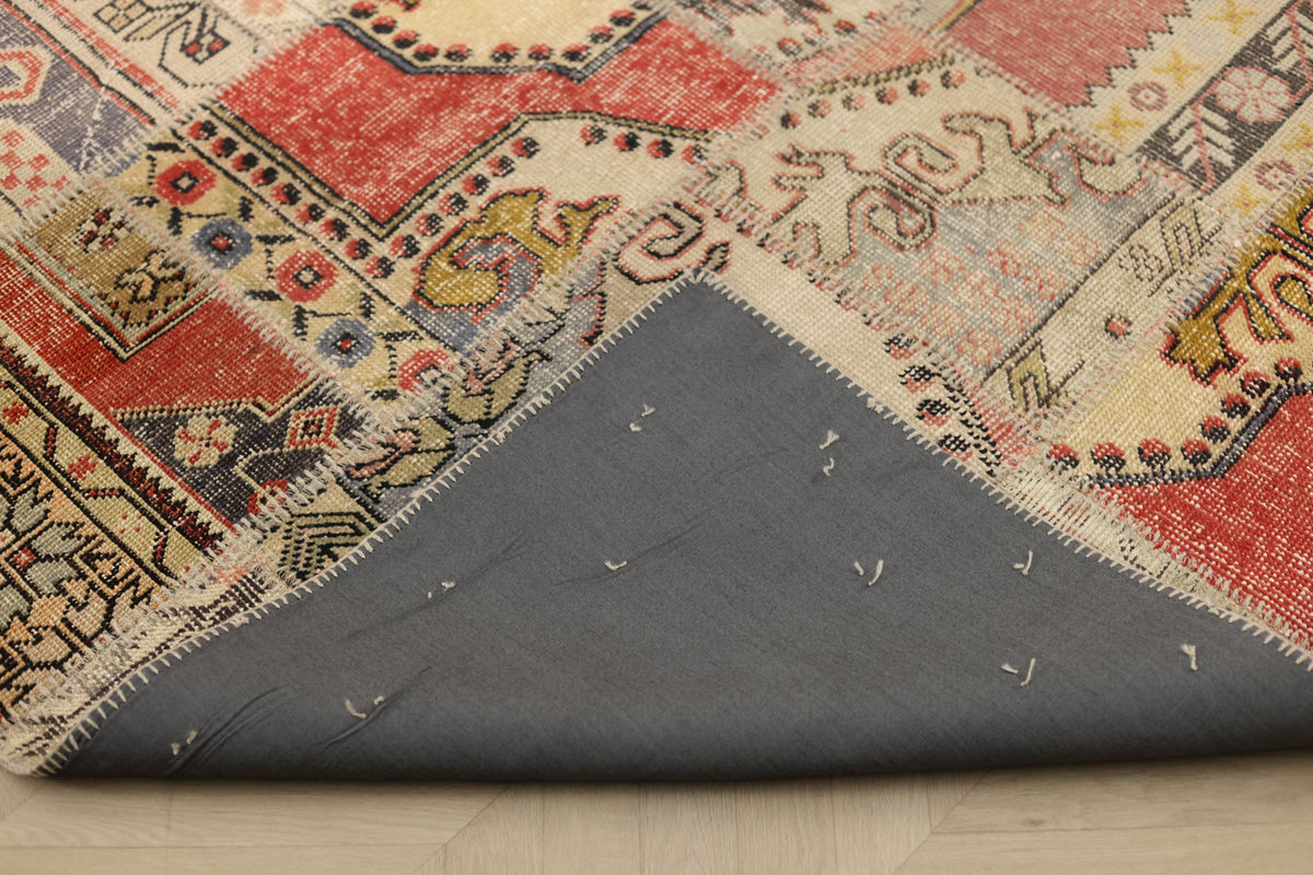 Handmade 6x9 patchwork Turkish rug with vibrant geometric patterns, wool and cotton construction, and grey fabric backing.