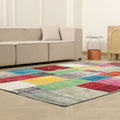 6x9 ft vintage Turkish patchwork area rug with vibrant, distressed wool and cotton squares in a bohemian living room.