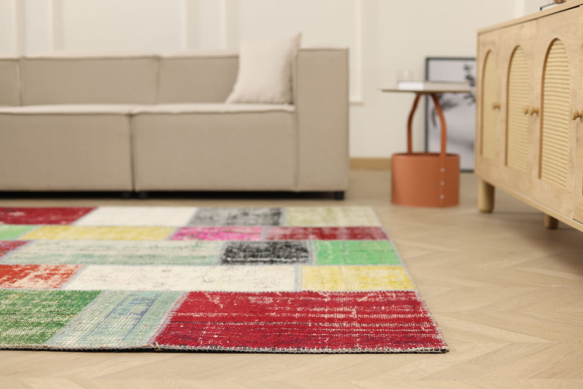 6x9 ft vintage Turkish patchwork area rug in vibrant mix-colors, crafted from distressed wool and cotton in a boho style.