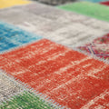Handmade 6x9 ft vintage Turkish patchwork rug featuring vibrant, distressed wool and cotton squares in a bohemian style.