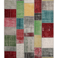 6x9 ft vintage Turkish patchwork area rug in wool and cotton with vibrant, distressed, multi-colored geometric panels.