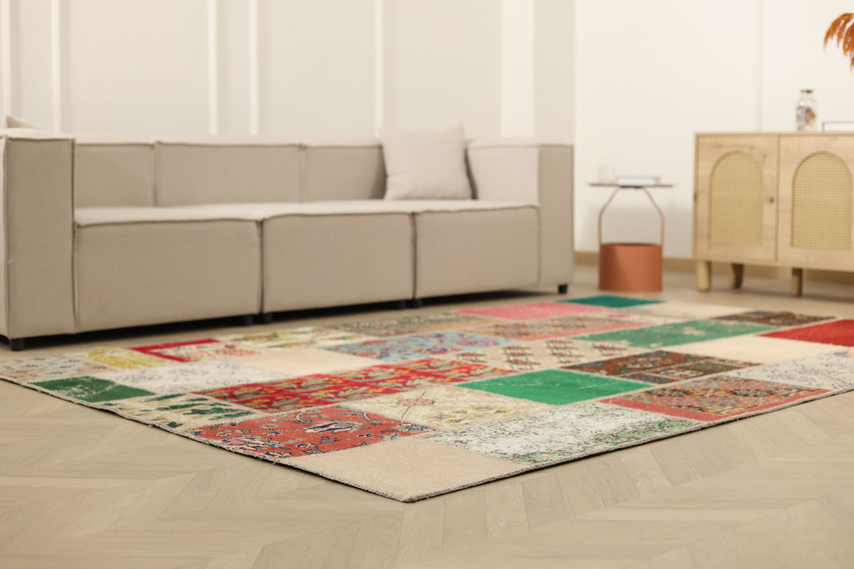 6x9 ft vintage Turkish patchwork area rug featuring vibrant floral patterns in wool and cotton on a light wood floor.