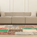 6x9 ft vintage Turkish patchwork area rug with vibrant floral patterns in wool and cotton, set in a modern living room.