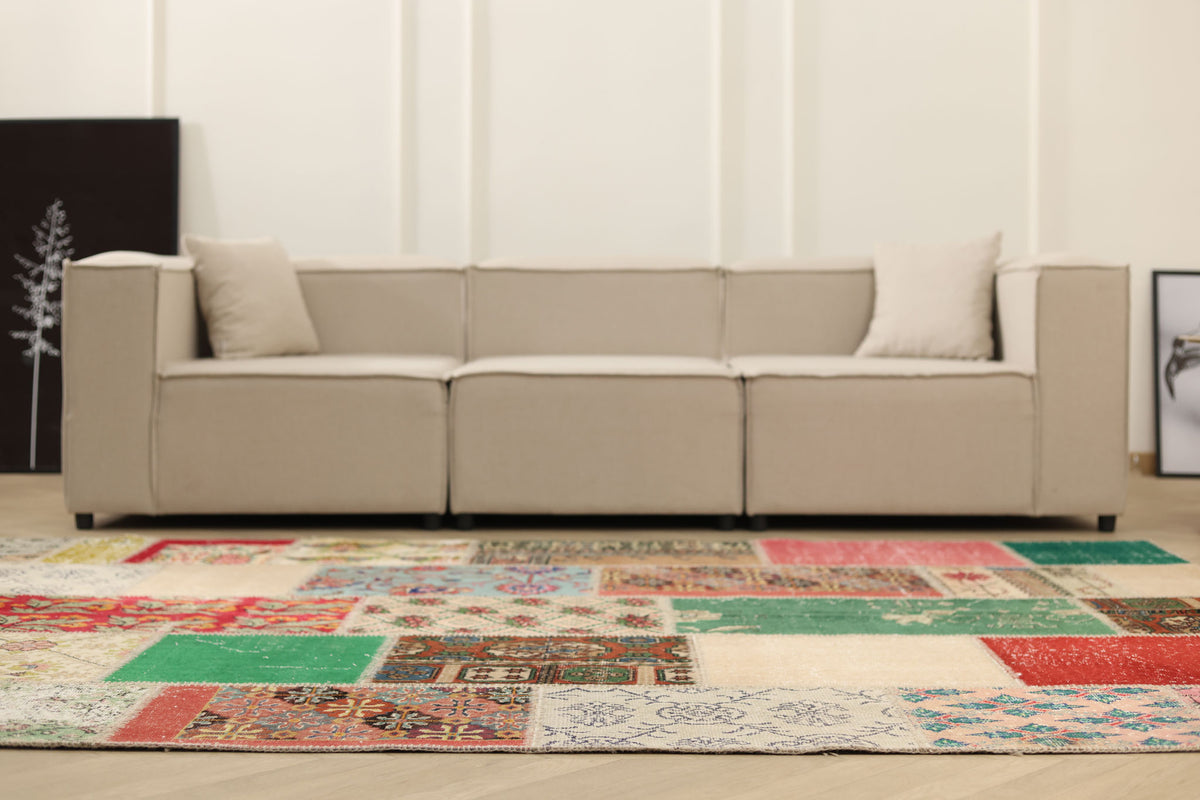 6x9 ft vintage Turkish patchwork area rug with vibrant floral patterns in wool and cotton, set in a modern living room.